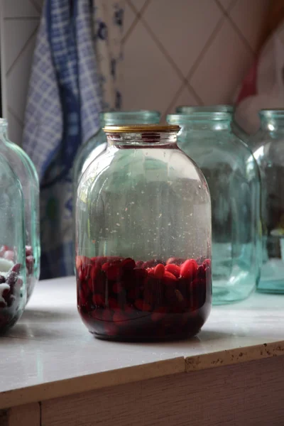 Cornel compote in a glass jar under the metal cover — Stock Photo, Image