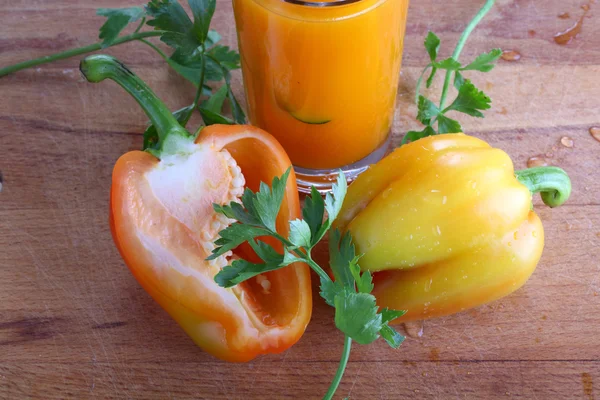 Karottensaft mit Kräutern und Pfeffer auf Holzbrett — Stockfoto