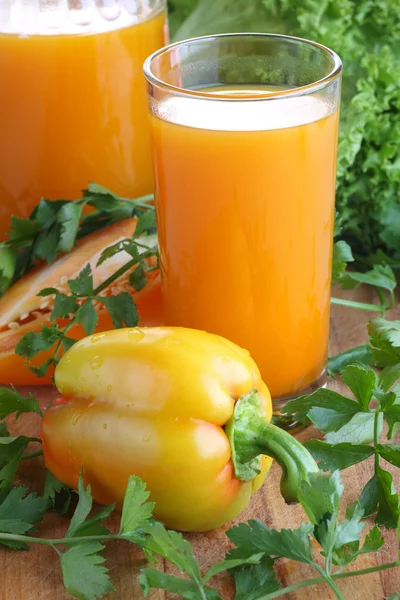 Succo di carota con erbe e pepe su tavola di legno — Foto Stock