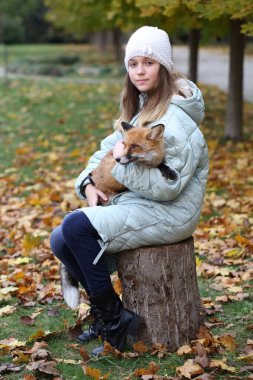 Bir kızın kollarında kızıl tilki