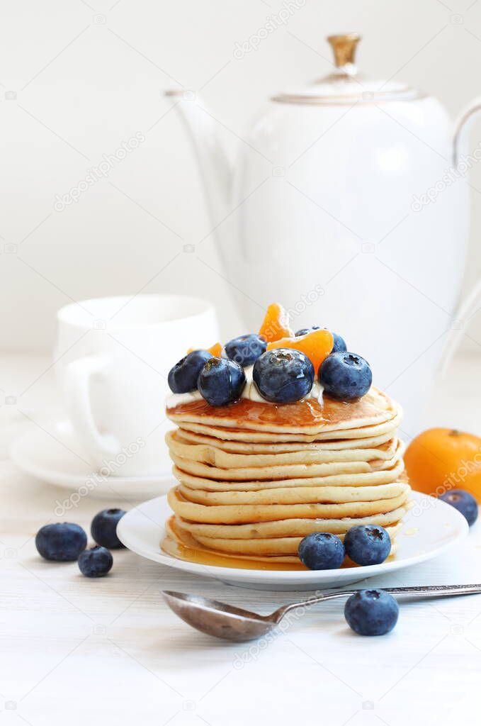 Pancakes with blueberries on a white background