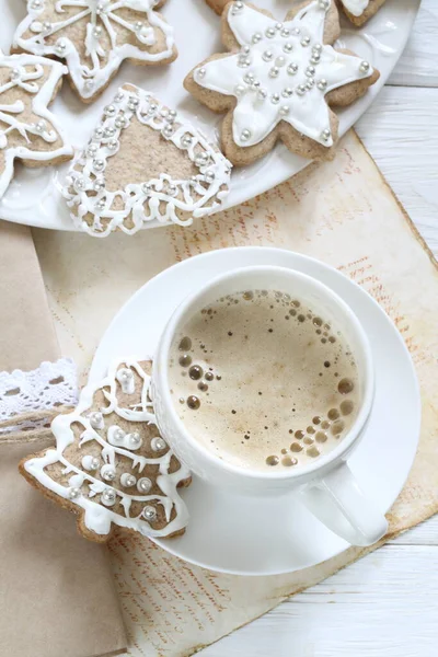 Gingerbread cookie with white icing and coffee