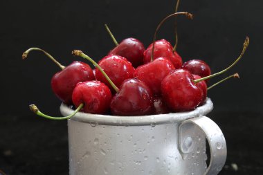 Sweet cherry. Red cherries in a mug