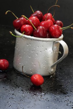 Sweet cherry. Red cherries in a mug