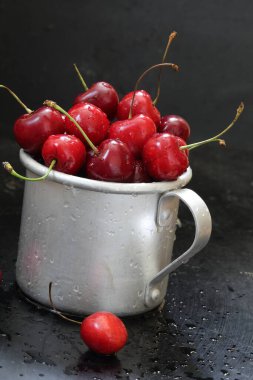 Sweet cherry. Red cherries in a mug