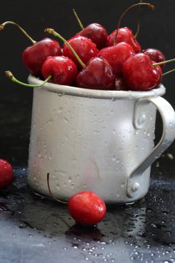 Sweet cherry. Red cherries in a mug