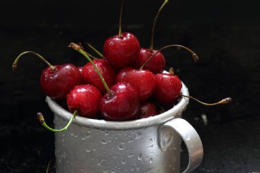 Sweet cherry. Red cherries in a mug