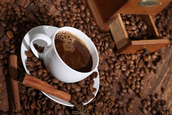 Still-life from coffee in a white cup, cinnamon, an anise and a — Stock Photo, Image