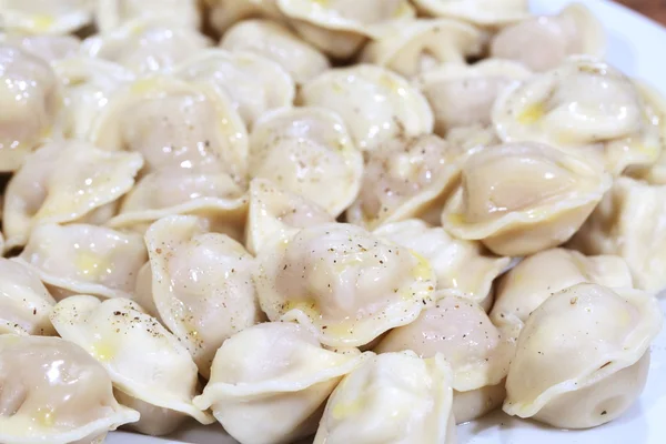 Pelmeni with butter and ground pepper — Stock Photo, Image