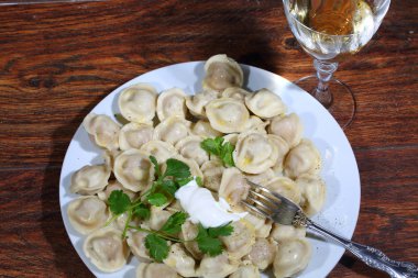 Şarap ve bir tabak içinde mantı