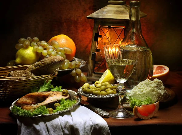 Salmon, wine, olives, cheese, grapes and a small lamp — Stock Photo, Image