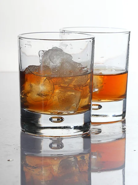 Two glasses with whisky and ice on a white background — Stock Photo, Image