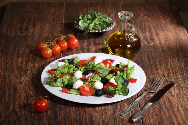 Salada com uma mussarela, tomates, azeitonas, salada — Fotografia de Stock