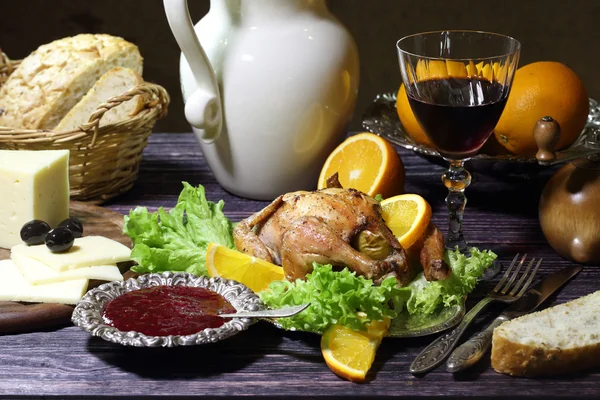 Chicken - kornishony and a red wine glass — Stock Photo, Image