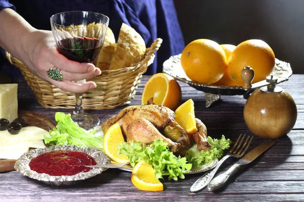 Poulet - kornishonie et un verre de vin rouge dans les mains des femmes — Photo