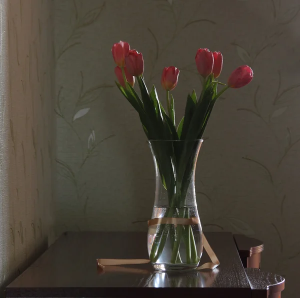 stock image Bouquet of pink tulips in a transparent vase