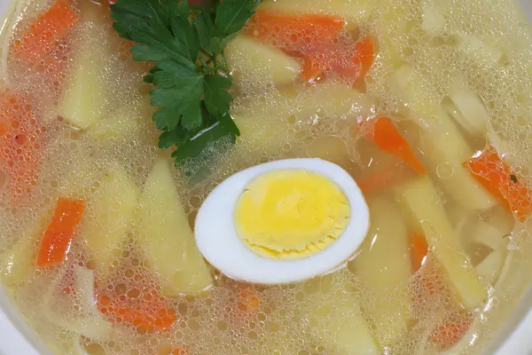 Chicken soup with house noodles and boiled egg — Stock Photo, Image