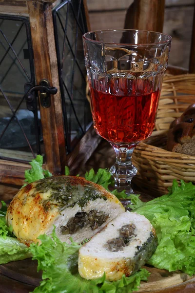 Wine in a glass and minced roll hens with a stuffing from mushro — Stock Photo, Image