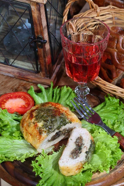 Wine in a glass and minced roll hens with a stuffing from mushro — Stock Photo, Image