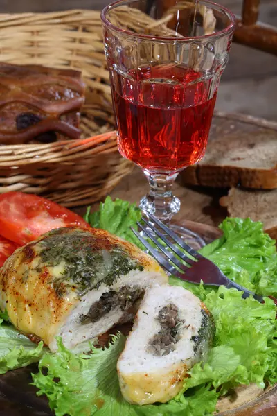 Wine in a glass and minced roll hens with a stuffing from mushro — Stock Photo, Image