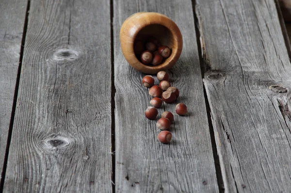 Wood nut in a wooden bowl on a wooden background — Stock Photo, Image