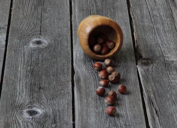 Wood nut in a wooden bowl on a wooden background — Stock Photo, Image