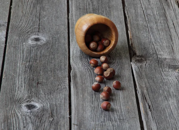 Wood nut in a wooden bowl on a wooden background — Stock Photo, Image