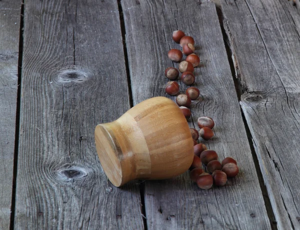 Wood nut in a wooden bowl on a wooden background — Stock Photo, Image