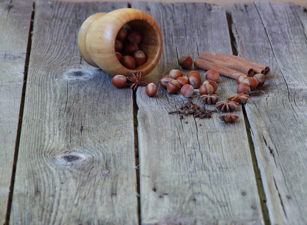Wood nut, asterisks of an anise, a stick of cinnamon and a carna — Stock Photo, Image