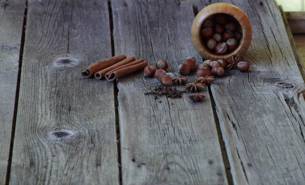 Wood nut, asterisks of an anise, a stick of cinnamon and a carna — Stock Photo, Image