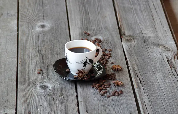 Café em uma xícara de café em um ambiente de grãos de café e um — Fotografia de Stock