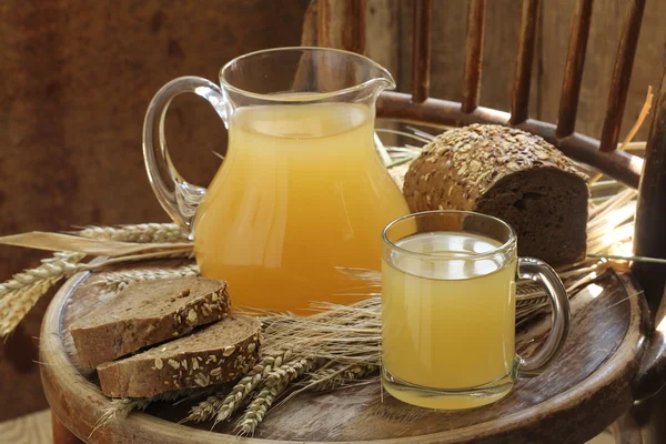 Kvass (Kvas) in a transparent mug, a jug and rye bread