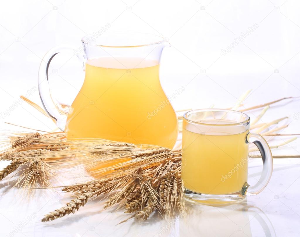 Grain drink - kvass (kvas) in a transparent jug on a white backg