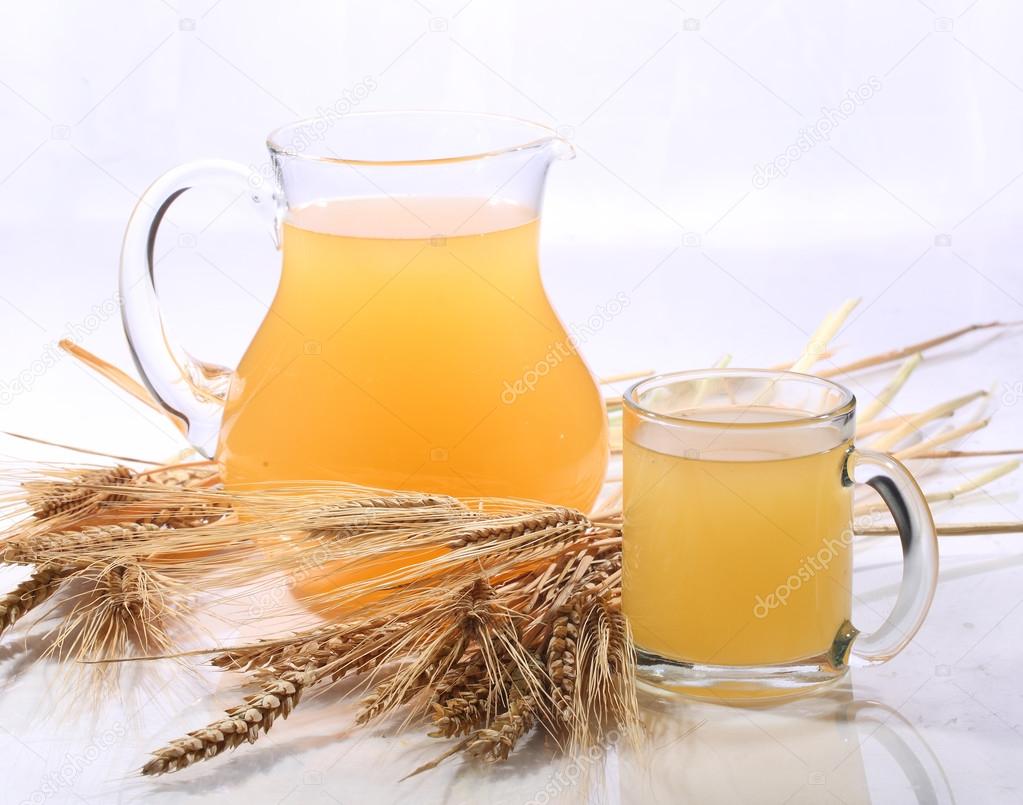 Grain drink - kvass (kvas) in a transparent jug on a white backg