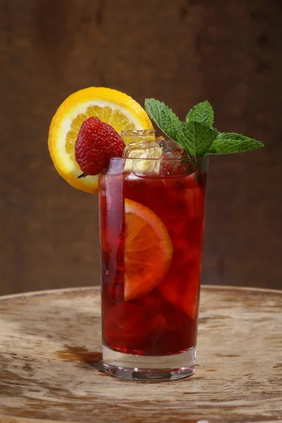 Wine of Sangrija in a transparent glass with a strawberry, an or — Stock Photo, Image