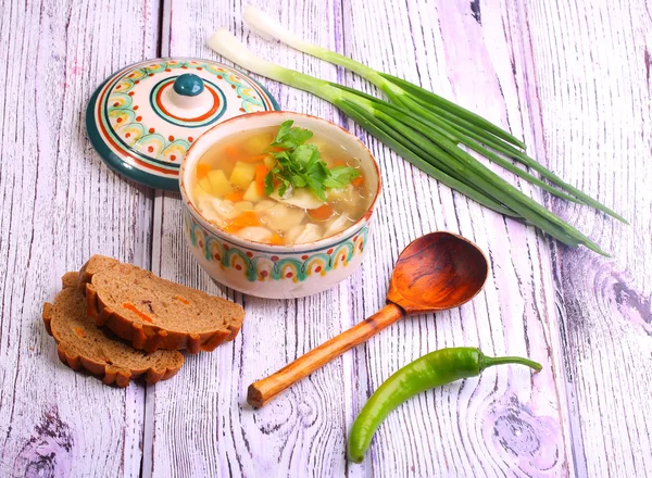 Soup with pelmeni, a potato, carrots submitted with a green onio — Stock Photo, Image