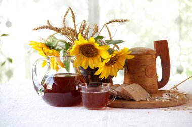 Kvas (kvas) ahşap bir kupa, ekmek ve ayçiçeği bir buket 