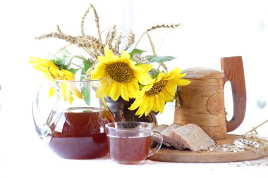 Kvas (kvas) ahşap bir kupa, ekmek ve ayçiçeği bir buket 