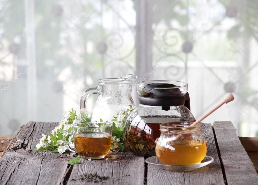 Honey in transparent bank, milk in a jug and tea in a transparen