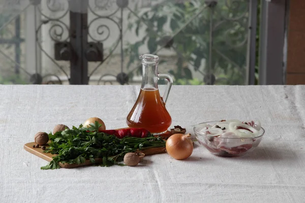 Fresh meat with rings of onions and spices and marinade for meat — Stock Photo, Image