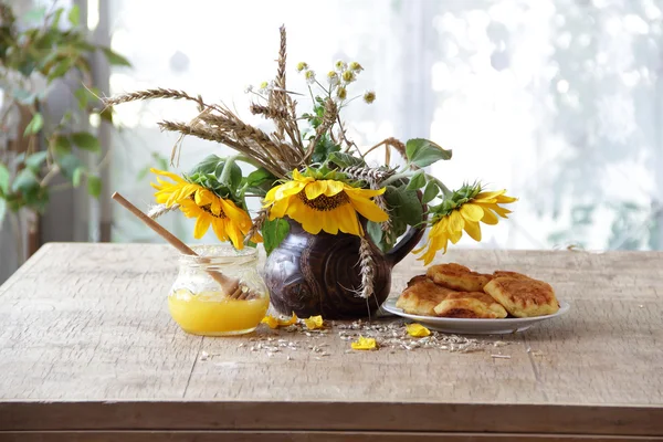Tartas de queso presentadas con miel y un ramo de girasoles — Foto de Stock