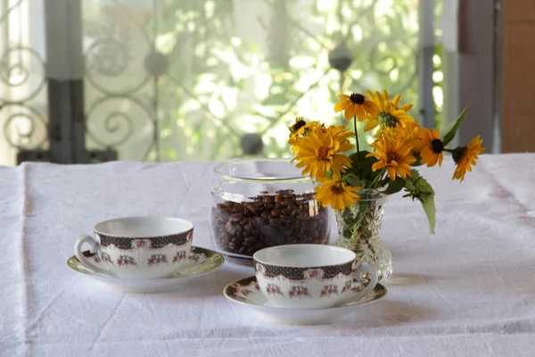 Zwei Tassen Kaffee und ein Blumenstrauß — Stockfoto