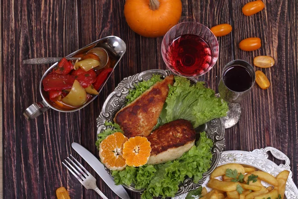 Chicken fillet in a crisp, French fries and a wine glass — Stock Photo, Image