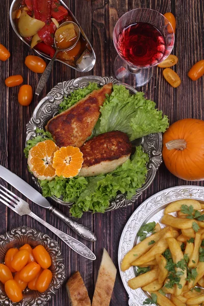 Chicken fillet in a crisp, French fries and a wine glass — Stock Photo, Image