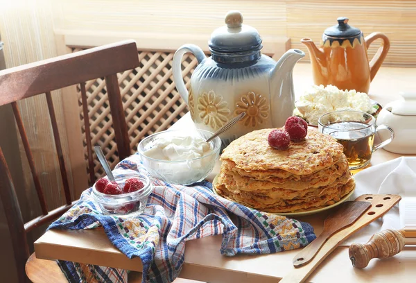 Panqueques con crema agria, una baya fresca y té . —  Fotos de Stock