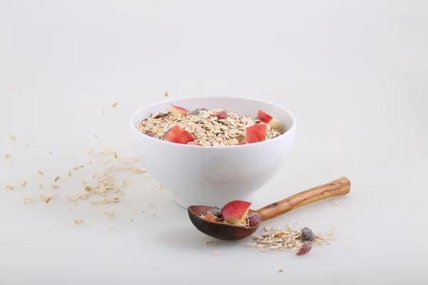 Porridge with dried fruits, nuts and a fresh apple — Stock Photo, Image