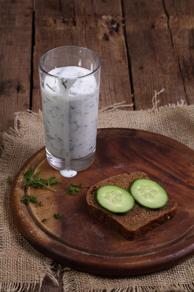 Cocktail from kefir with a cucumber on a wooden table — Stock Photo, Image