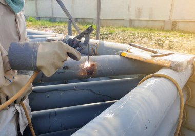 Teknisyenler çatı sütunları yapmak için yapısal çelik üretiyorlar..