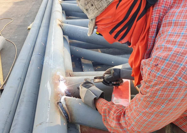 Steel pole welders for industrial roof support in midday