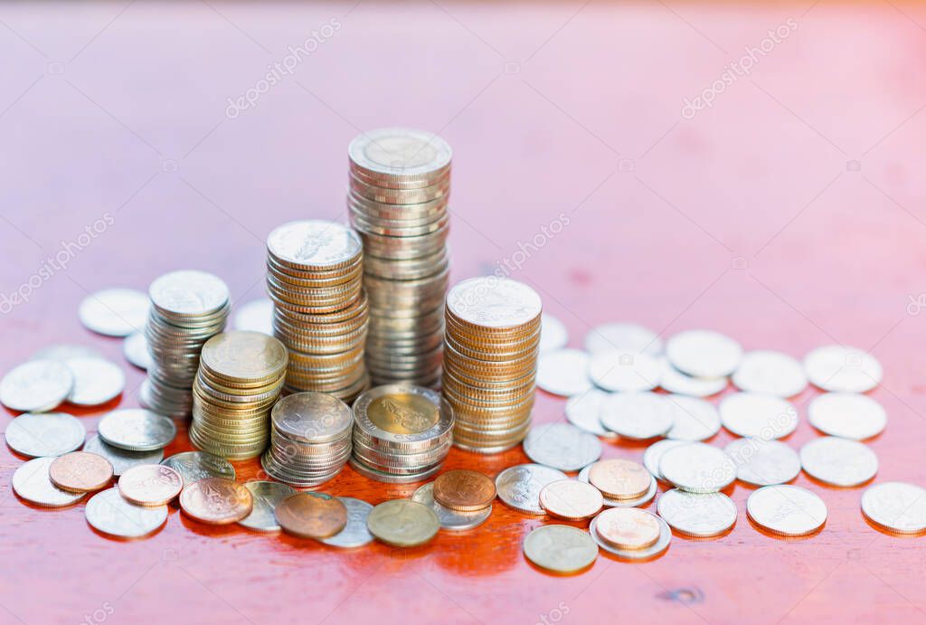 A pile of coin savings concept on wood background.